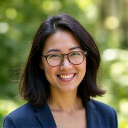 Portrait of Sarah Chen, a professional facilitator, smiling confidently.