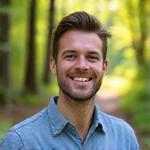 Portrait of Liam O'Connell, a seasoned naturalist, with a friendly expression.