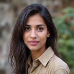 Portrait of Sara Khan, a wildlife photographer and conservationist, holding a camera.